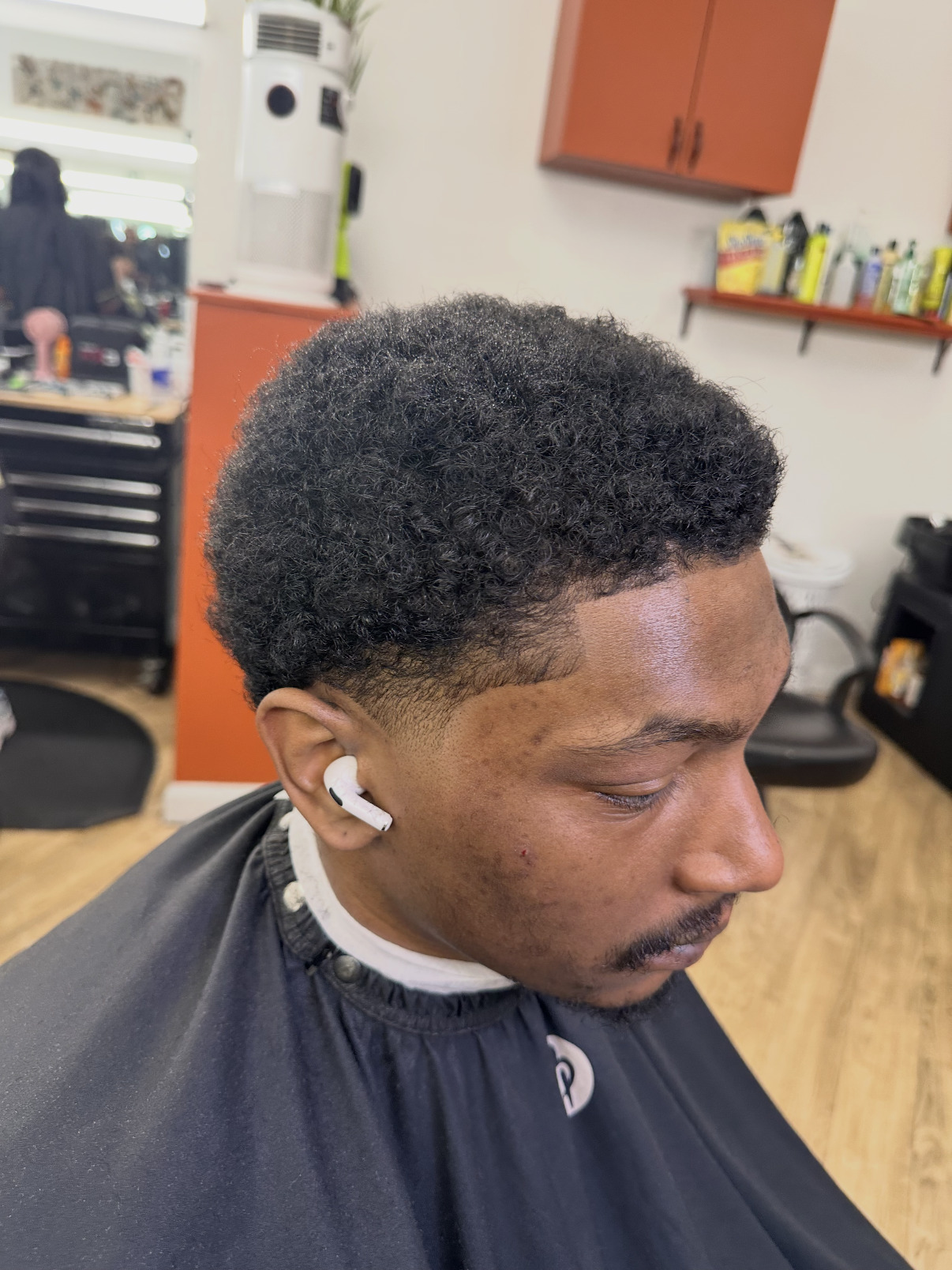 Textured taper cut with a crisp line-up on a client at Supremes Barbershop